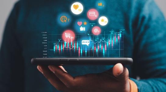 Handing holding phone horizontally with graphics of different apps floating above.