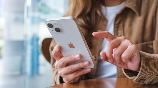 woman using latest iphone with ios 18