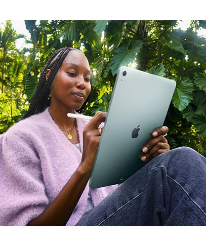 A woman using a new iPad Air.